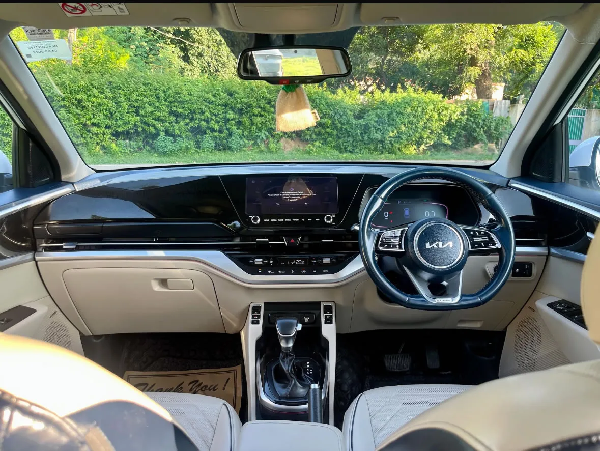 Interior of the KIA Carens automatic, highlighting the spacious 7-seater configuration for car rentals in Goa.