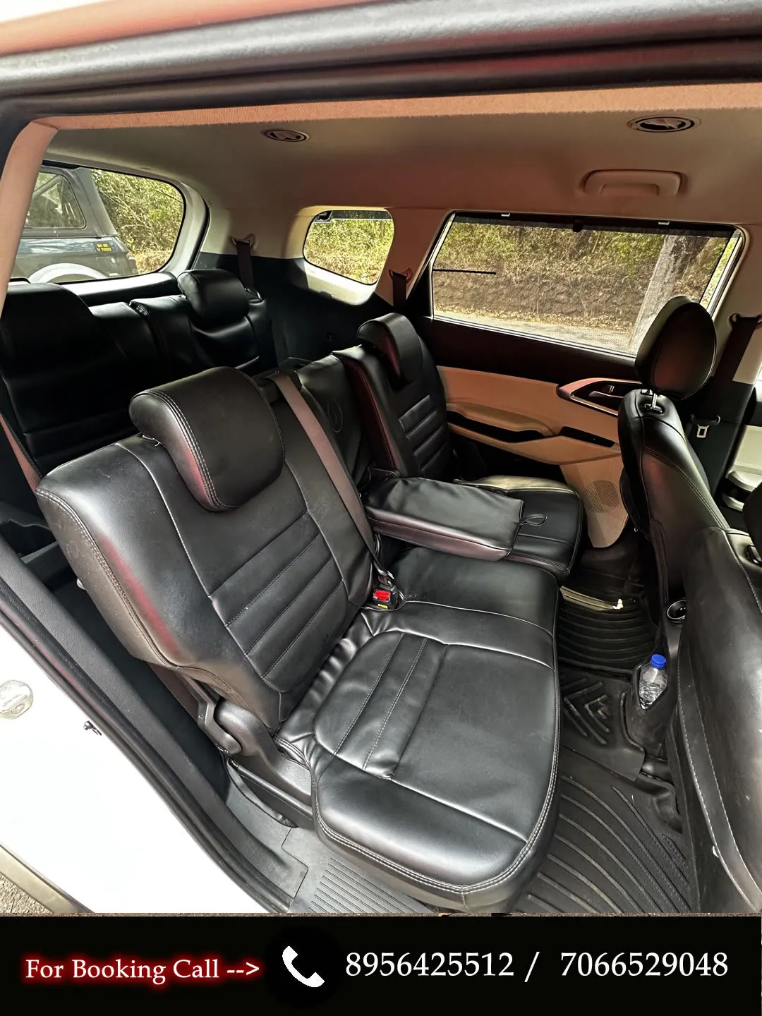 Spacious interior of the manual KIA Carens, a comfortable car for hire in Goa.