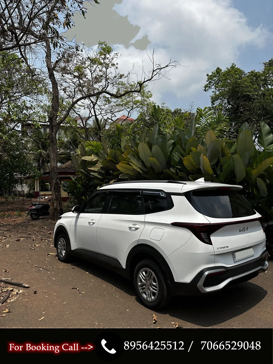 Back-side view of the KIA Carens, a manual MPV available for car rentals in Goa.