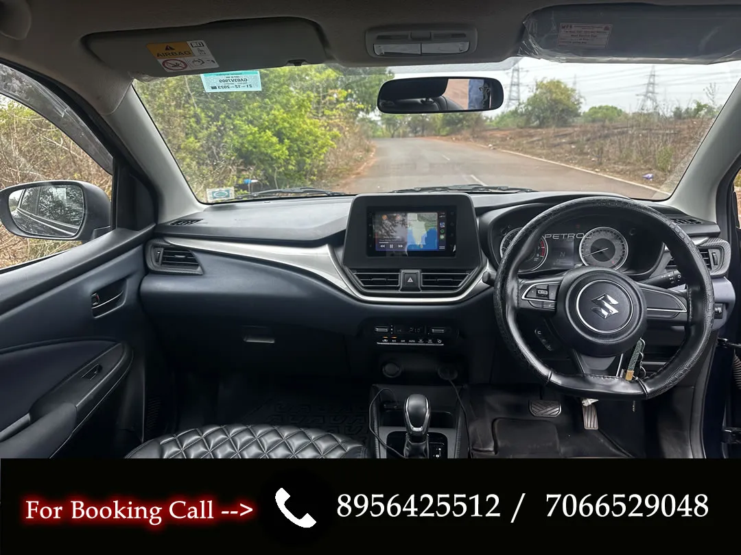 Close-up of the front seats and dashboard of the Maruti Baleno, a top choice for car rentals in Goa.