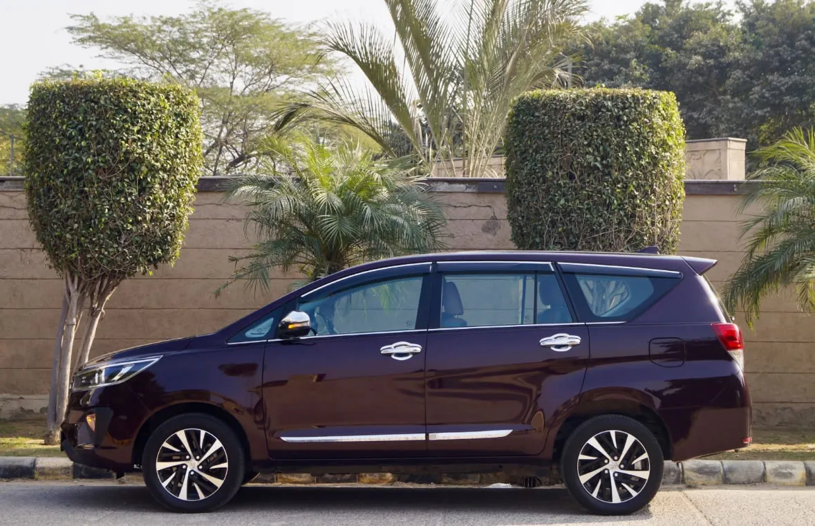 Side profile of the Toyota Innova Crysta, a diesel MPV for car rentals in Goa.